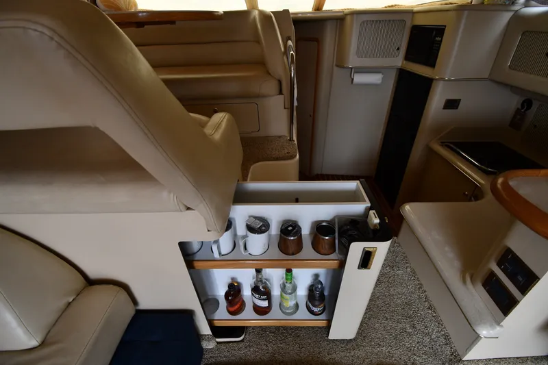 Slide: The Image of Interior of 1998 Sea Ray 400 Sedan Bridge with built-in bar and seating area. - 53