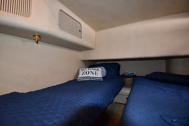 Slide: The Image of Cozy cabin interior of 1998 Sea Ray 400 Sedan Bridge with twin beds and nautical decor. - 38