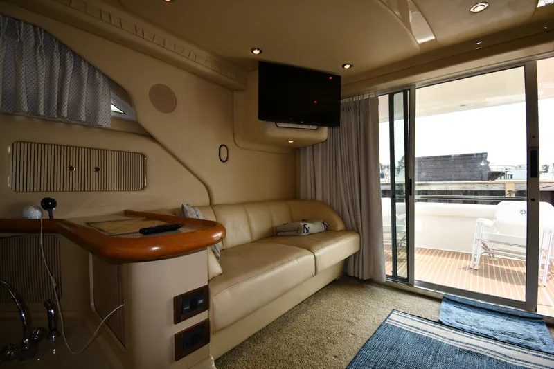 Slide: The Image of Interior of 1998 Sea Ray 400 Sedan Bridge yacht with sofa, TV, and sliding glass door. - 43