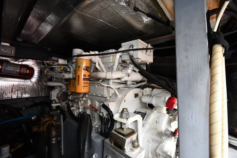 Slide: The Image of Engine room of 1998 Sea Ray 400 Sedan Bridge with visible CAT filter and components. - 57