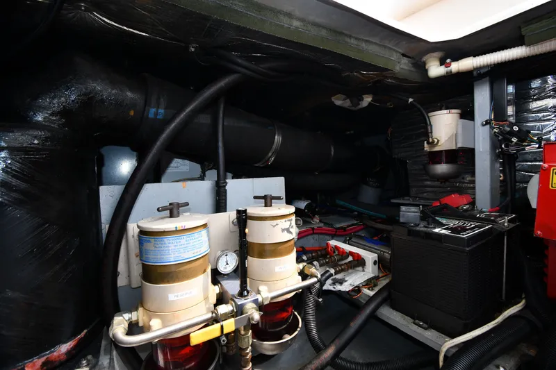 Slide: The Image of Engine room of 1998 Sea Ray 400 Sedan Bridge with fuel filters and battery. - 62