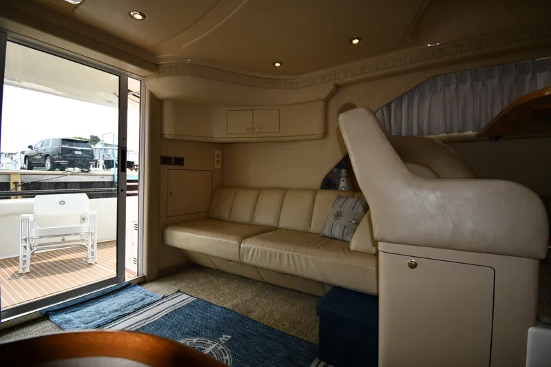 Slide: The Image of Interior of 1998 Sea Ray 400 Sedan Bridge yacht with beige seating and nautical decor. - 42