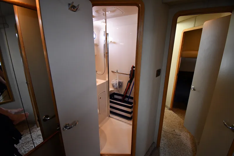 Slide: The Image of Interior of 1998 Sea Ray 400 Sedan Bridge, featuring bathroom and hallway. - 34
