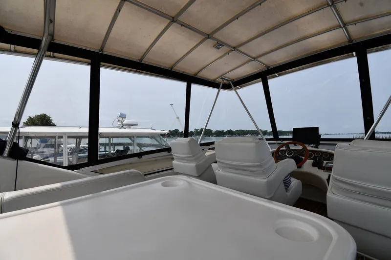 Slide: The Image of Interior view of 1998 Sea Ray 400 Sedan Bridge yacht with helm and seating area. - 17