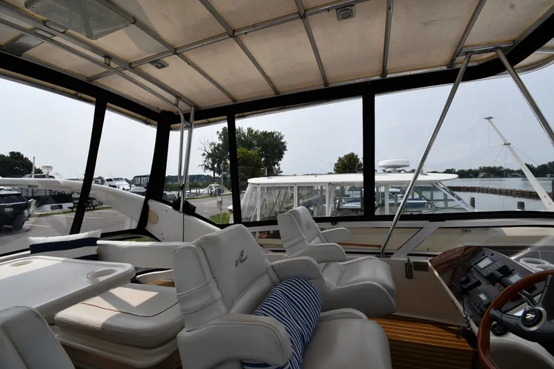 Slide: The Image of Interior view of 1998 Sea Ray 400 Sedan Bridge yacht with plush seating and helm. - 18
