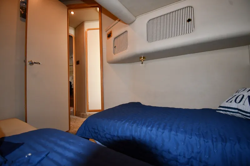 Slide: The Image of Interior cabin of 1998 Sea Ray 400 Sedan Bridge with twin beds and blue bedding. - 39