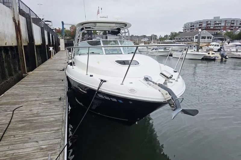 Slide: The Image of 2008 Sea Ray 290 Amberjack docked at a marina, showcasing sleek design and modern features. - 7