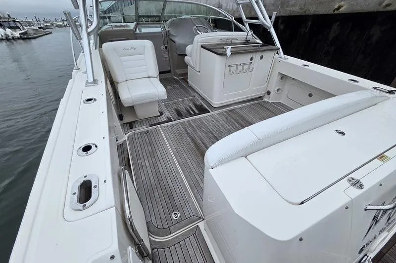 Slide: The Image of 2008 Sea Ray 290 Amberjack boat interior with seating and helm, docked at marina. - 9