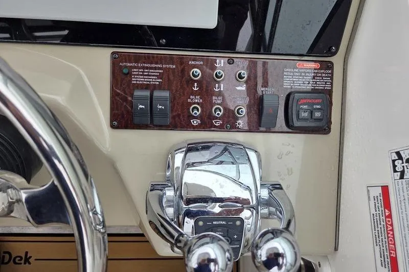 Slide: The Image of Control panel of a 2008 Sea Ray 290 Amberjack boat with switches and throttle. - 16