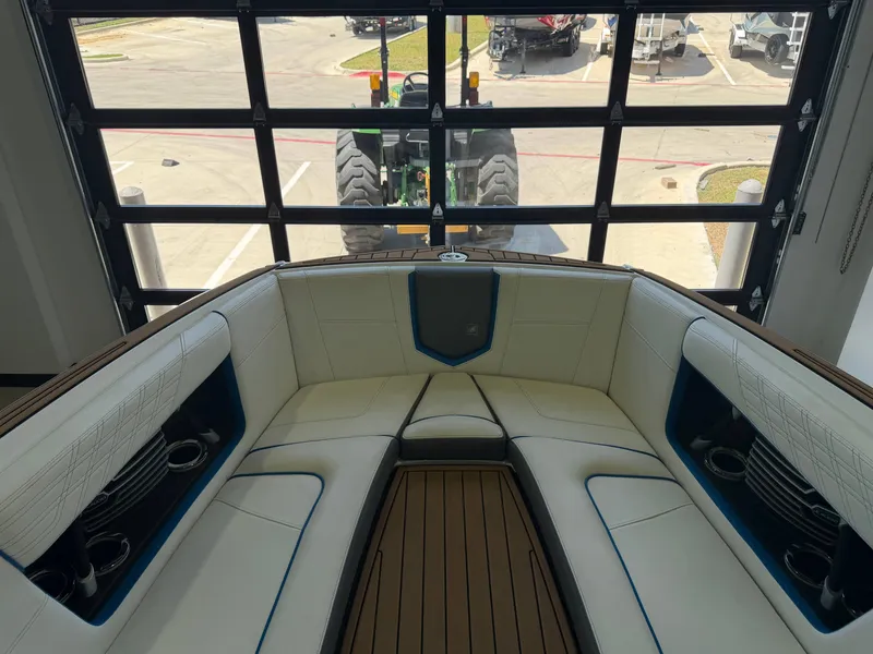Slide: The Image of The image shows the bow area of a 2019 Nautique Super Air Nautique G25 with white upholstery. - 9