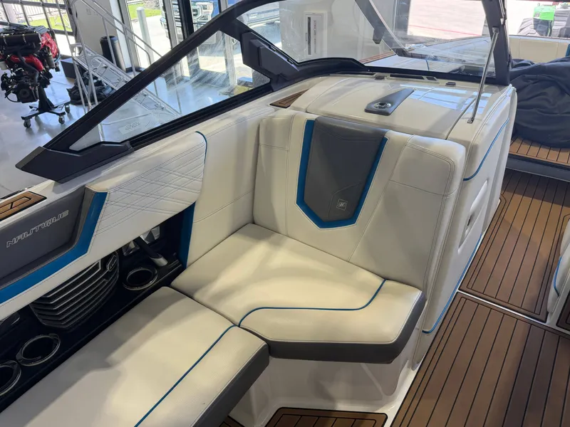 Slide: The Image of Interior of a 2019 Nautique Super Air Nautique G25 with white upholstery and blue accents. - 7