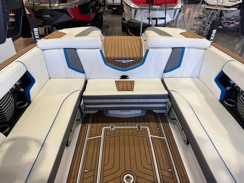 Slide: The Image of The image shows the interior of a 2019 Nautique Super Air Nautique G25 with sleek white and blue upholstery. - 10
