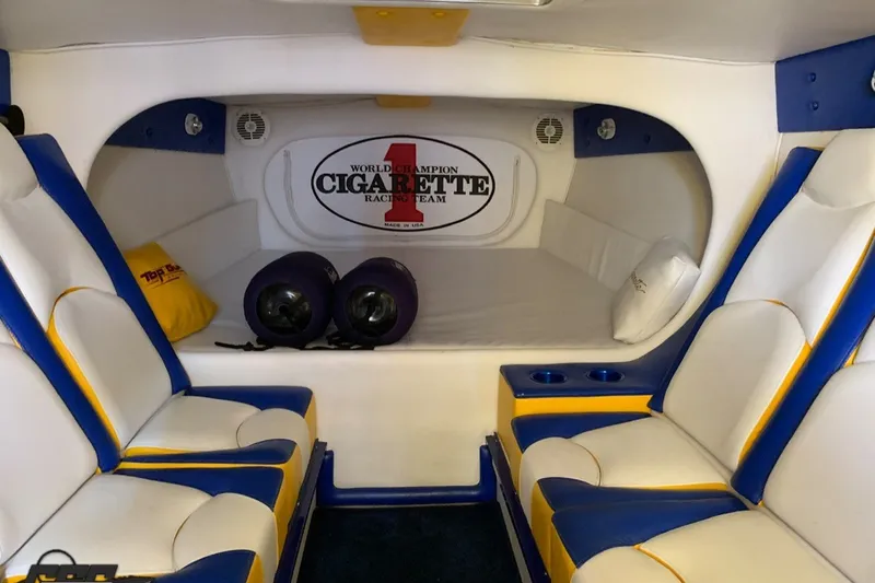 Slide: The Image of Interior of 2005 Cigarette 39' Top Gun Unlimited boat with blue and yellow seating. - 19