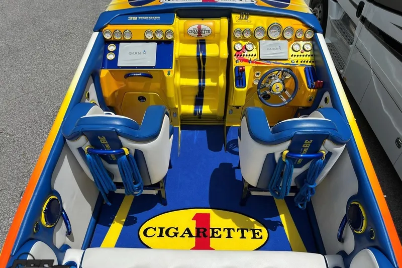 Slide: The Image of 2005 Cigarette 39' Top Gun Unlimited boat interior with vibrant blue and yellow design. - 16