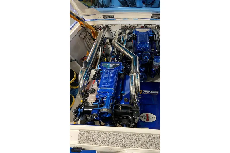 Slide: The Image of 2005 Cigarette 39' Top Gun Unlimited boat engine, featuring polished chrome and blue components. - 21