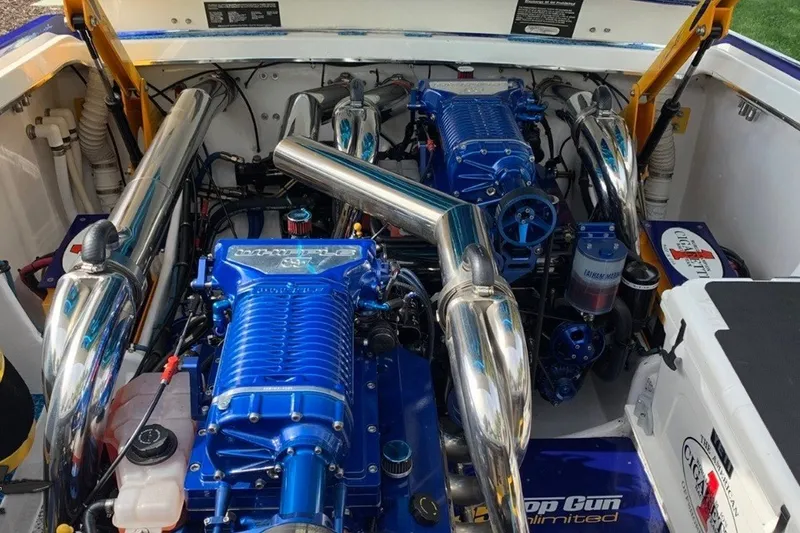 Slide: The Image of Engine compartment of a 2005 Cigarette 39' Top Gun Unlimited boat, featuring dual blue engines. - 22