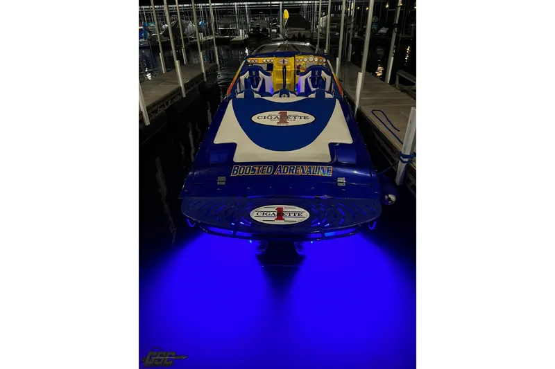 Slide: The Image of 2005 Cigarette 39' Top Gun Unlimited boat with blue LED lights at night. - 14