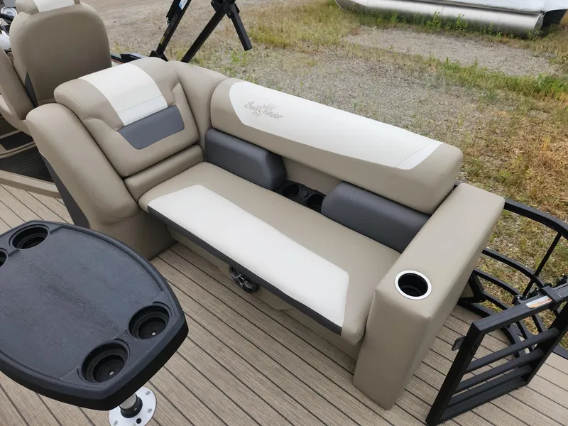 Slide: The Image of Seating area on a SunChaser Eclipse 8523 LR DH pontoon boat with beige upholstery and cup holders. - 10