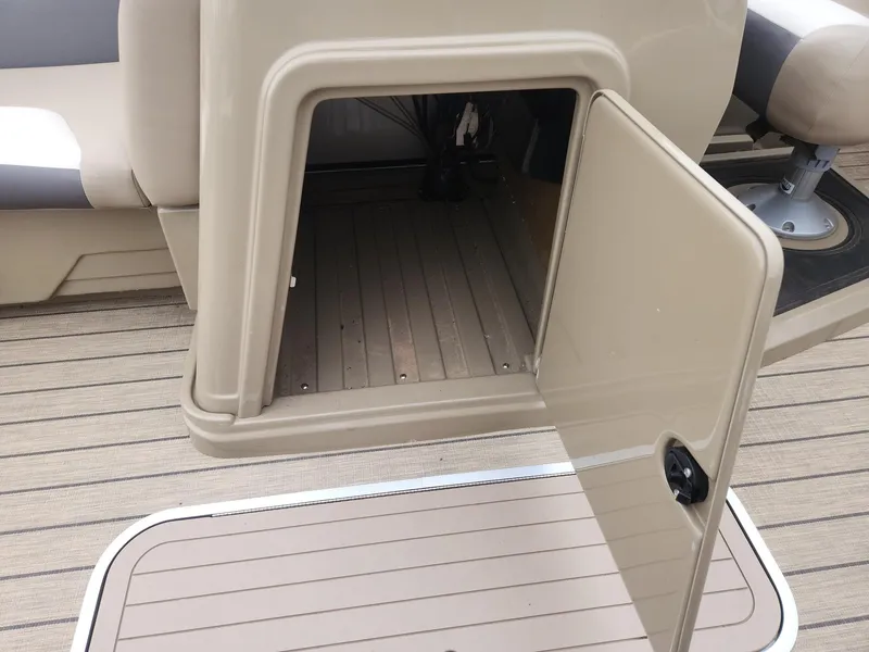 Slide: The Image of An open storage compartment on a 2023 SunChaser Eclipse 8523 LR DH boat. - 19