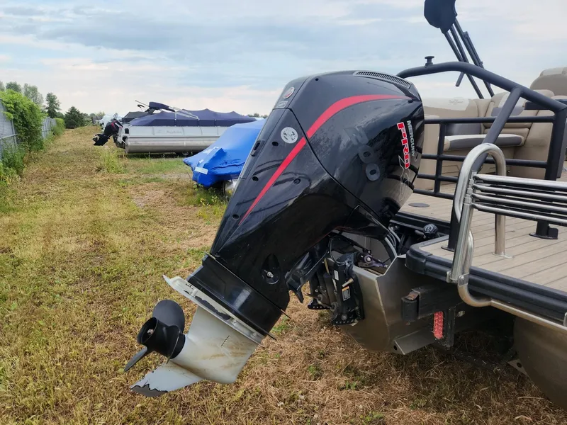 Slide: The Image of An outboard motor is attached to a SunChaser Eclipse 8523 LR DH boat. Other boats are visible in the background. - 5