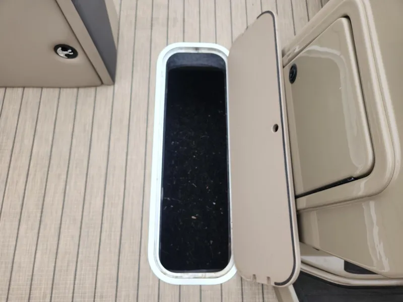 Slide: The Image of An open storage compartment on a boat with wood-patterned flooring. - 18