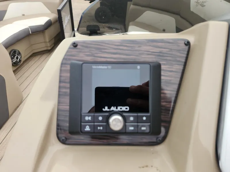 Slide: The Image of The image shows a JL Audio marine radio on a SunChaser Eclipse 8523 LR DH boat. - 16