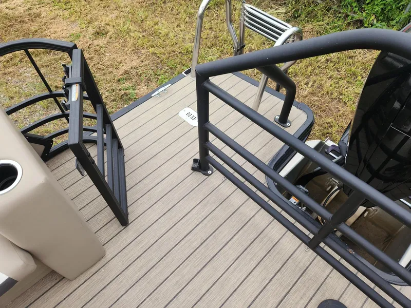Slide: The Image of The image shows the rear of a SunChaser Eclipse 8523 LR DH pontoon boat with a swim platform and ladder. - 11