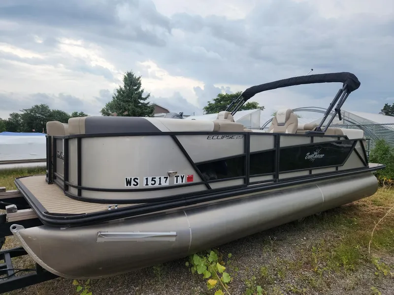 Slide: The Image of A 2023 SunChaser Eclipse 8523 LR DH pontoon boat on a trailer under a cloudy sky. - 3