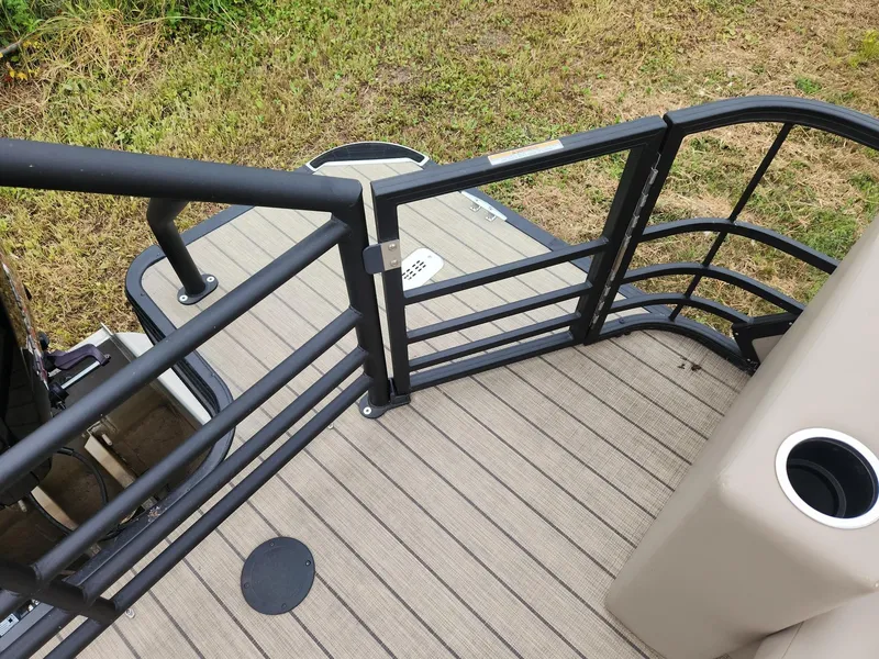 Slide: The Image of The image shows the rear of a SunChaser Eclipse 8523 LR DH pontoon boat with sturdy railing. - 13