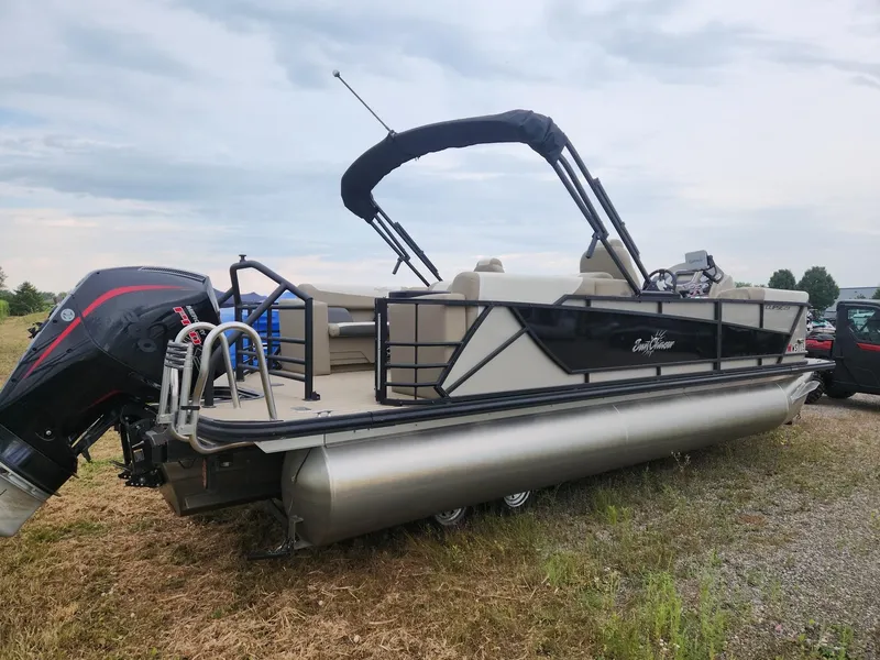 Slide: The Image of A 2023 SunChaser Eclipse 8523 LR DH pontoon boat on a trailer in a grassy area. - 4