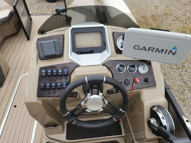 Slide: The Image of The image shows the helm of a SunChaser Eclipse 8523 LR DH boat with Garmin navigation. - 14
