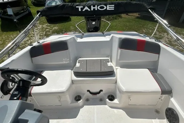 Slide: The Image of 2022 Tahoe T16 boat interior with seating and steering wheel, featuring modern design elements. - 17
