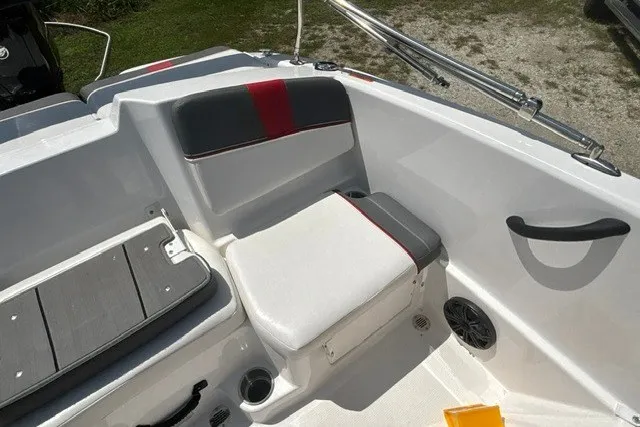 Slide: The Image of 2022 Tahoe T16 boat interior with cushioned seating and storage compartments. - 18