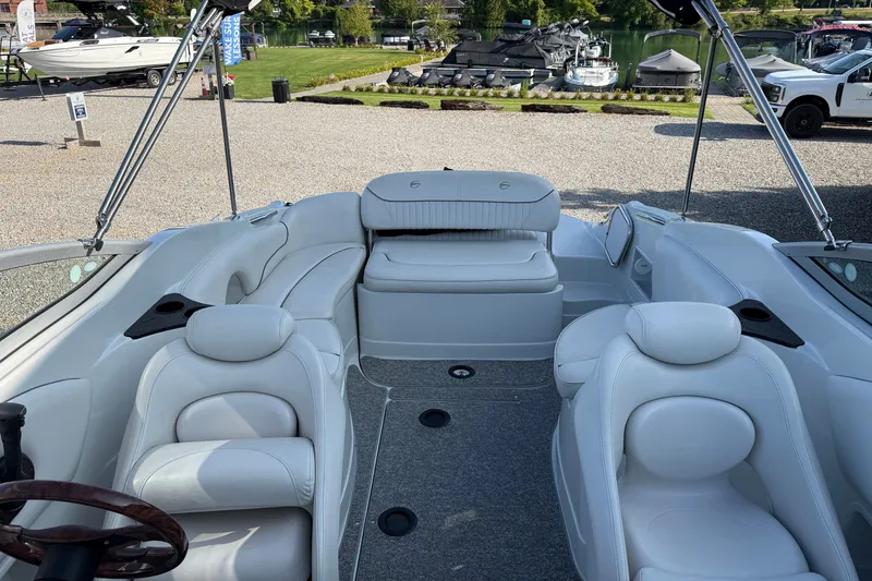 Slide: The Image of 2005 Crownline 275 CCR boat interior with white seating and lake view. - 18