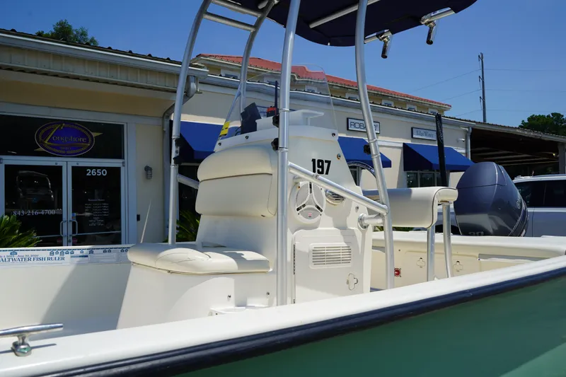 Slide: The Image of 2015 Key West 197 Skiff boat with seating and console, displayed outdoors. - 12