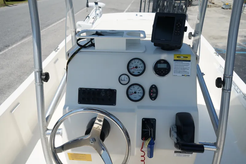 Slide: The Image of Center console of a 2015 Key West 197 Skiff boat with steering wheel and gauges. - 8