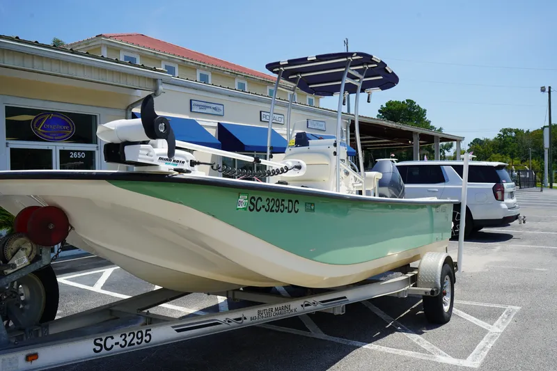 Slide: The Image of 2015 Key West 197 Skiff boat on trailer in parking lot, sunny day. - 2