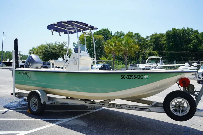 Slide: The Image of 2015 Key West 197 Skiff boat on trailer in sunny parking lot. - 13