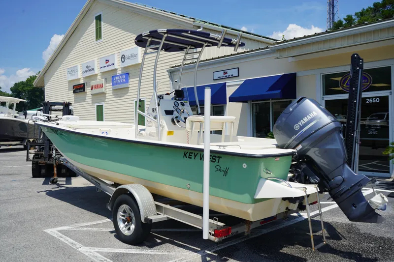 Slide: The Image of 2015 Key West 197 Skiff boat with Yamaha motor on trailer, parked outside dealership. - 3