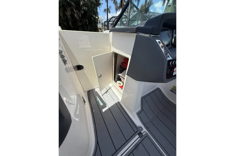 Slide: The Image of 2020 Chaparral 257 SSX boat interior with open storage compartment and sleek design. - 17