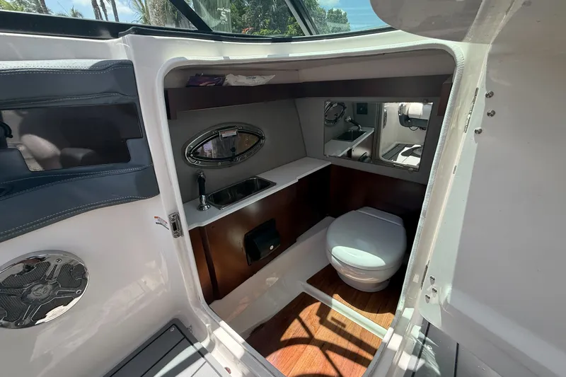 Slide: The Image of 2020 Chaparral 257 SSX boat interior with compact bathroom and sink. - 15