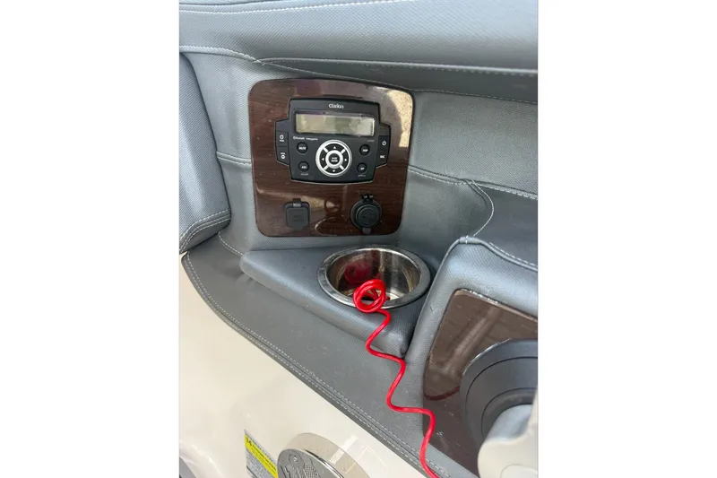 Slide: The Image of 2020 Chaparral 257 SSX boat dashboard with stereo system and cup holder. - 26