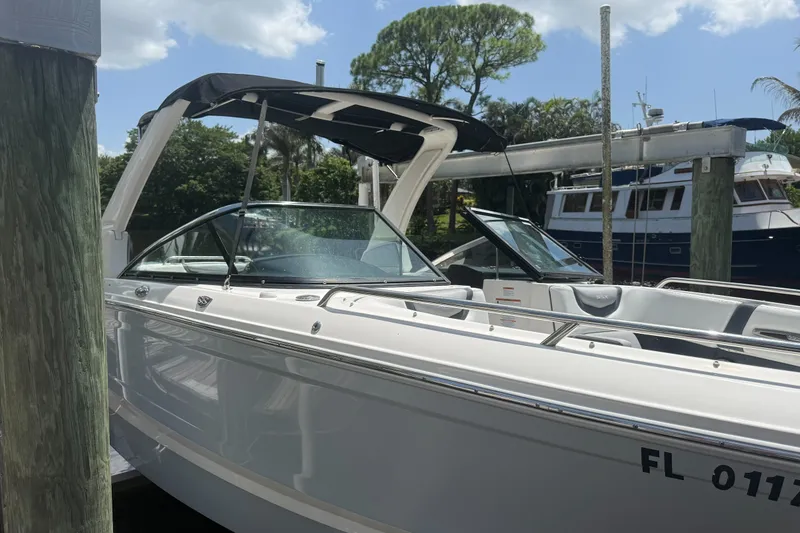 Slide: The Image of 2020 Chaparral 257 SSX boat docked, featuring sleek design and canopy. - 3