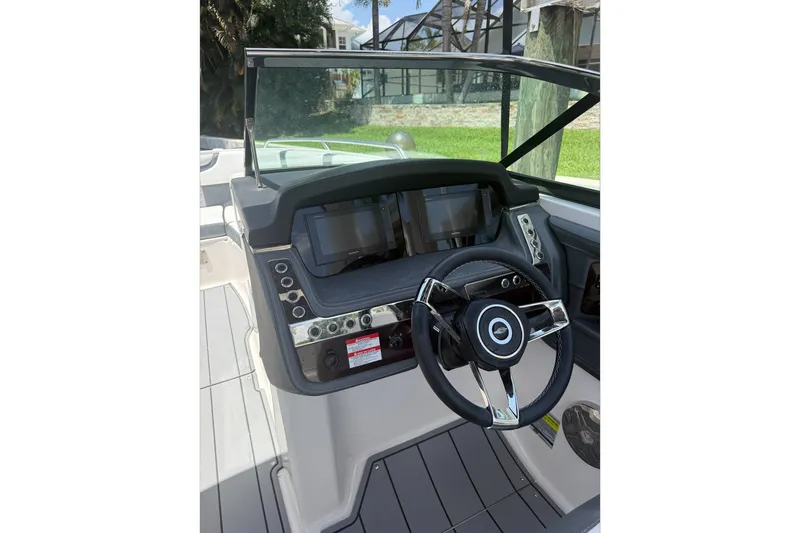 Slide: The Image of 2020 Chaparral 257 SSX boat dashboard with steering wheel and digital display. - 12