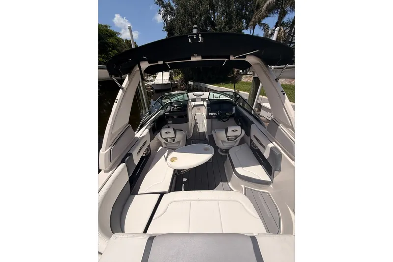 Slide: The Image of 2020 Chaparral 257 SSX boat interior with seating and helm, under sunny skies. - 9