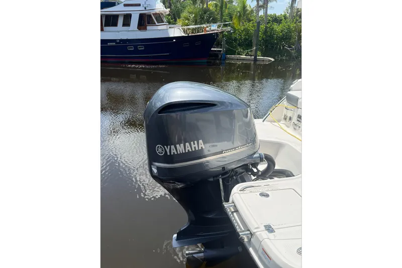 Slide: The Image of Yamaha outboard motor on 2020 Chaparral 257 SSX boat, docked near a canal. - 29