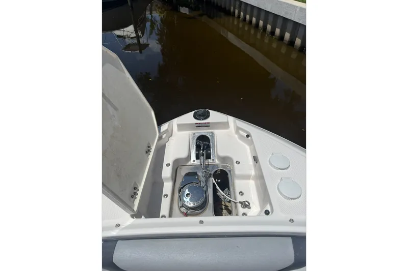 Slide: The Image of 2020 Chaparral 257 SSX boat anchor compartment with open hatch, dockside view. - 19