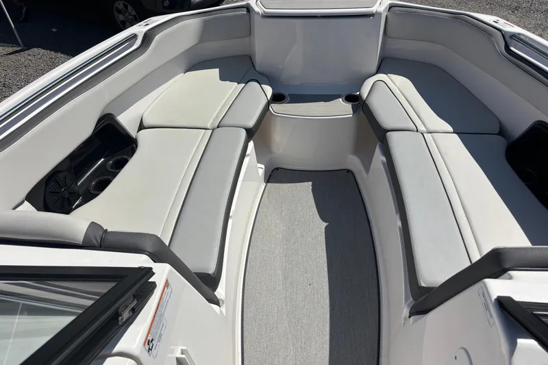 Slide: The Image of Interior view of 2023 Yamaha Boats AR250, featuring spacious seating and cup holders. - 12