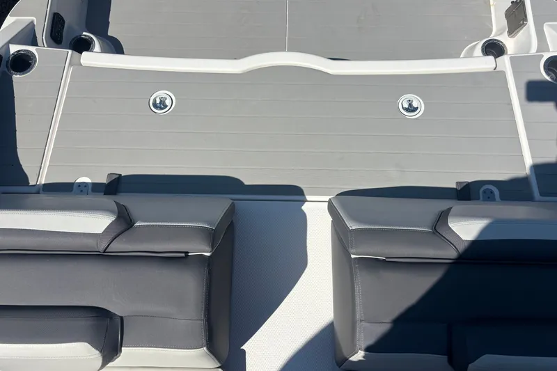 Slide: The Image of 2023 Yamaha Boats AR250 interior seating and deck, featuring sleek gray and black design. - 8