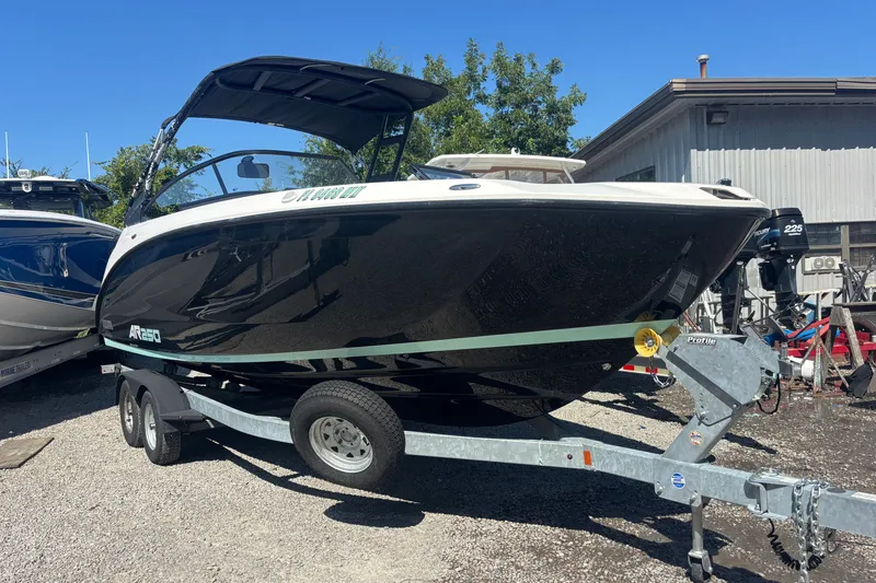 Slide: The Image of 2023 Yamaha Boats AR250 on trailer, black hull, parked outdoors. - 3